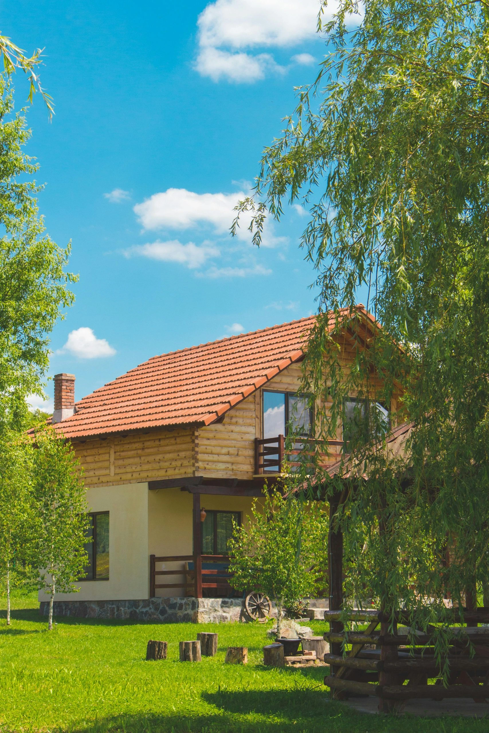 House behind trees with clean red roof