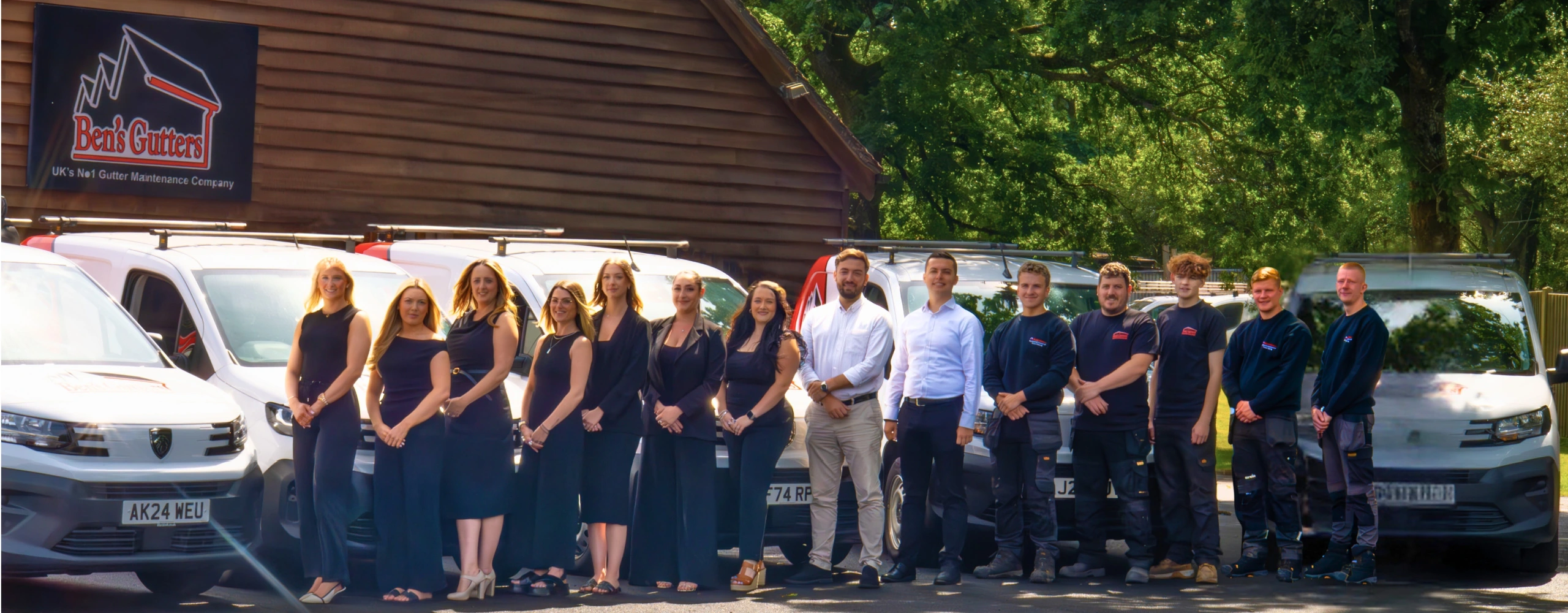 Gloucester gutter cleaning team from Ben’s Gutters standing beside service vans