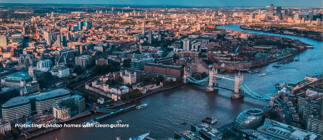 This is a drone shot showing an urban landscape of central London with multiple distinctive landmarks most commonly in this image: Tower Bridge. This image shows a good collage of roofs to give the idea of what gutter cleaners frequently deal with especially in London where its more commonly a rainy climate.