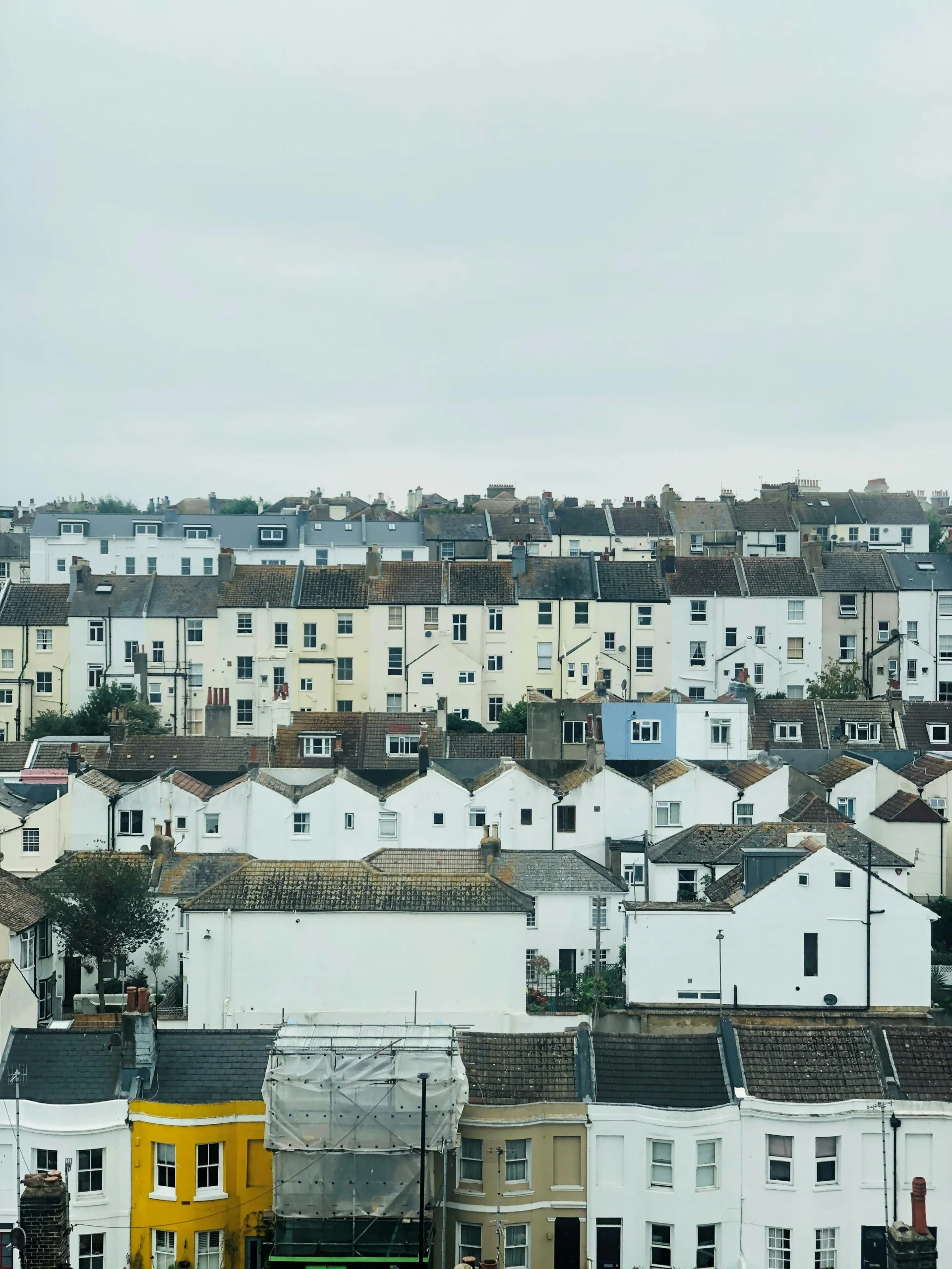 a portrait image showing a collage of houses with roofs, the purpose of this image is to provide context that gutter cleaners are commonly climbing up to these roofs to clean gutters