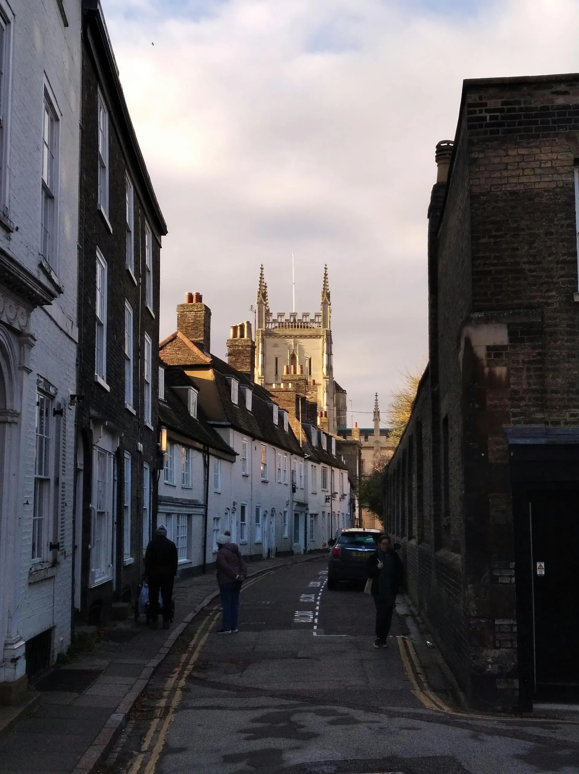 A narrow street in Cambridge showing a typical residents in the area that need their gutters cleaned.